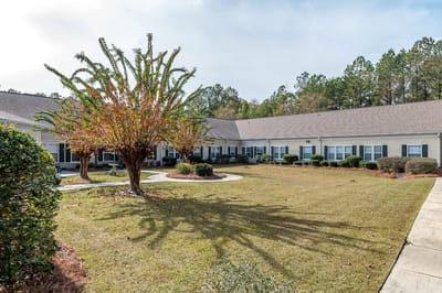 Well-maintained garden area with walking paths and trees