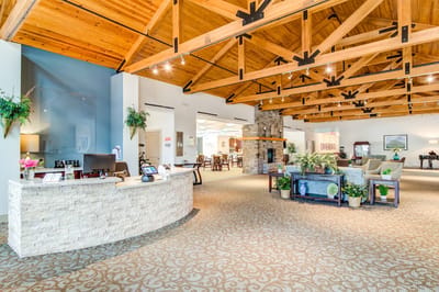 Bright interior common area with seating and a reception desk