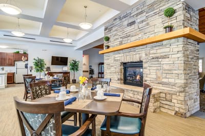 Dining area with tables set and a fireplace