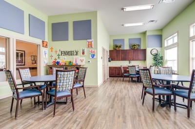Bright and welcoming common area with chairs and tables