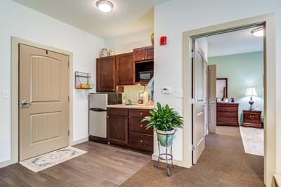Interior view of a private resident room with kitchenette