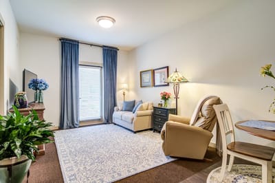 Cozy interior of a resident room with a sofa and lamp