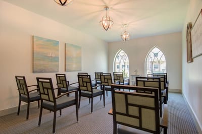 Bright activity room with arched windows and seating