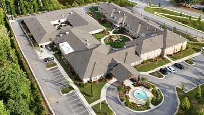Aerial view of a senior living facility with landscaped grounds