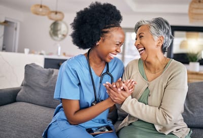 Caregiver and resident sharing a joyful moment