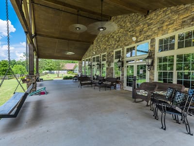 Covered outdoor seating area with a view of the lawn