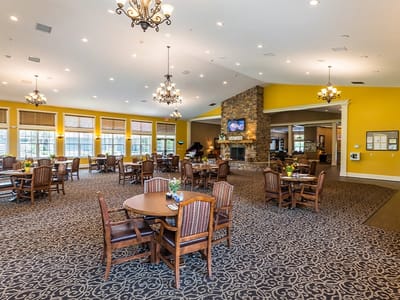 Interior view of a spacious common area with dining tables