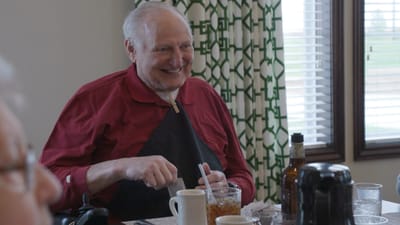 A resident enjoying a meal during a gathering