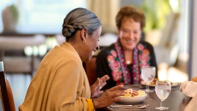 Two women enjoying a meal in a dining area