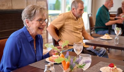 Residents enjoying dessert in the dining room