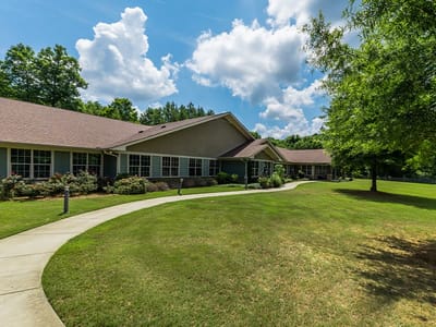Exterior view of Cedarhurst of Canton with walking path and greenery