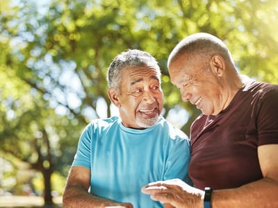 Two seniors enjoying a conversation outdoors