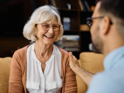 Senior woman joyfully engaging with a staff member