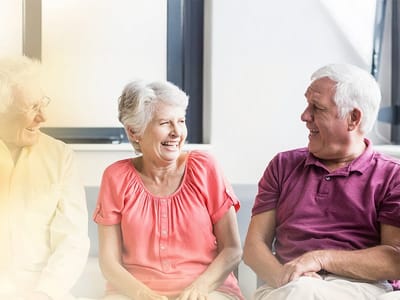 Seniors smiling and chatting in a common area