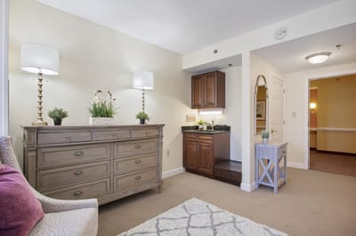 Cozy interior living area with a dresser and kitchenette