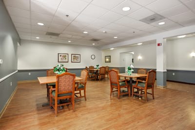 Dining area with tables and chairs set for residents