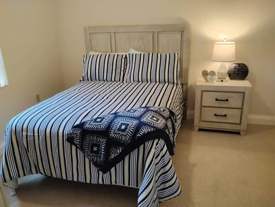 Cozy private resident room with bed and lamp