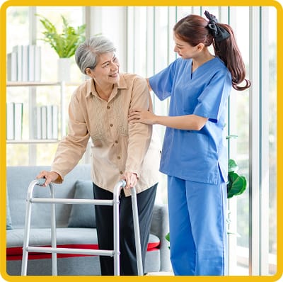 Caregiver assisting a resident in a bright common area