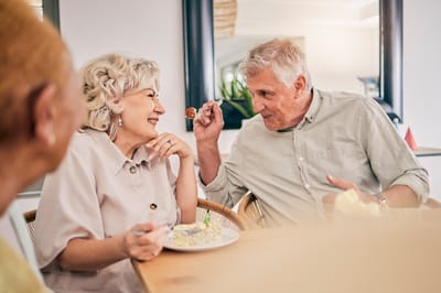 Residents enjoying a meal together in a dining room