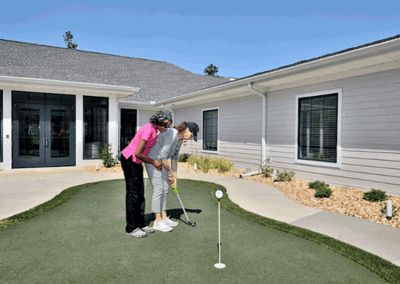 Residents engaging in outdoor putting activity