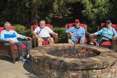 Residents relaxing by an outdoor fire pit