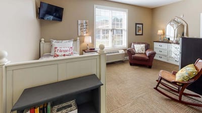 Cozy interior of a resident room with a bed and furniture