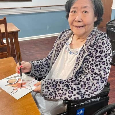 Resident painting in an art activity session