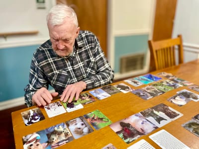 Senior resident engaging in a memory card game