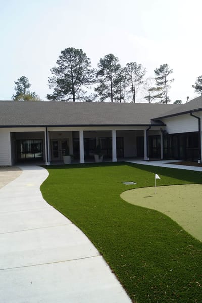 Outdoor putting green with landscaped grounds