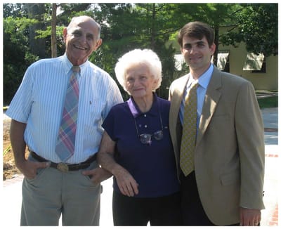 Residents and staff members smiling outdoors