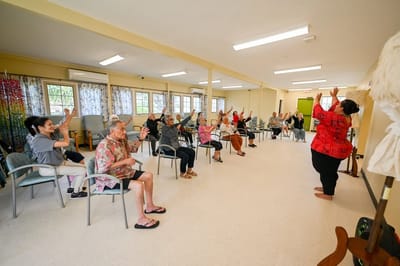 Residents participating in a seated exercise class