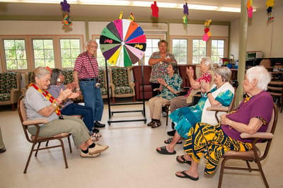 Residents engaging in a fun activity with a spinning wheel