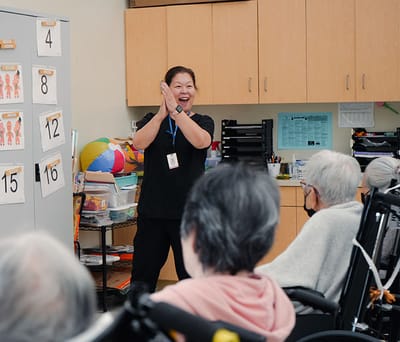 Activity session with an engaged staff member and residents