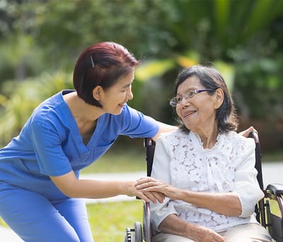 Caregiver interacting with a resident outdoors