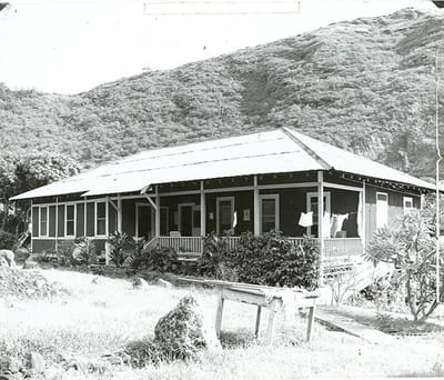 Exterior view of a historic building surrounded by greenery