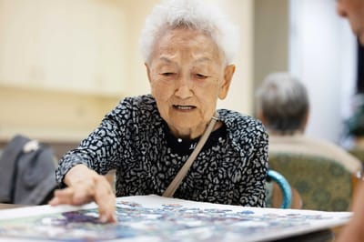 Senior resident engaged in an activity at a table
