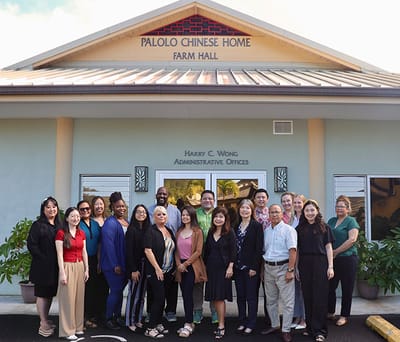 Group photo of staff in front of facility entrance