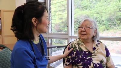Caregiver interacting with a smiling resident