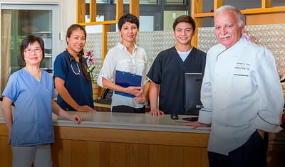 Staff members smiling at the reception desk