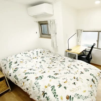 Cozy resident room with bedding and workspace