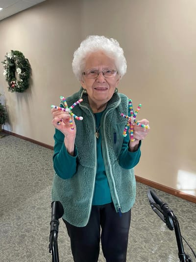Resident showcasing a craft in a common area
