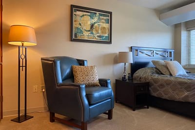 Cozy interior of a resident room with a chair and lamp