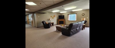 Cozy common area with seating and a TV