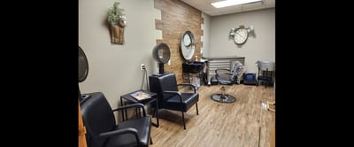 Interior of a salon area with chairs and mirrors