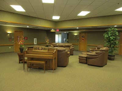 Cozy common area with seating and a piano