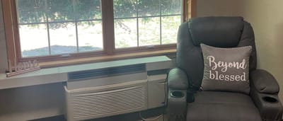 Cozy chair by a window with a decorative pillow