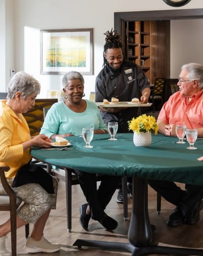 Residents enjoying dessert in the dining area