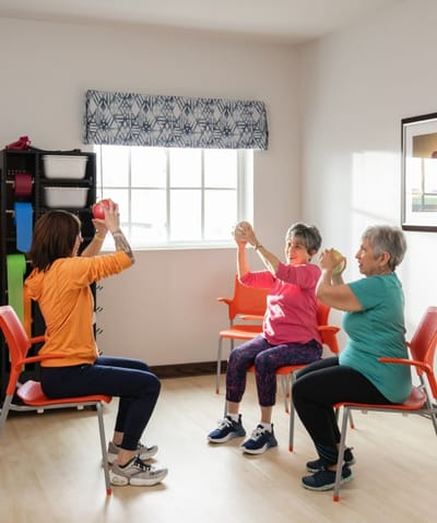 Residents participating in an exercise class indoors