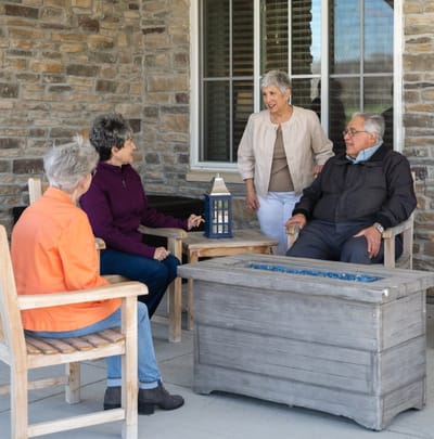 Residents enjoying conversation on an outdoor patio