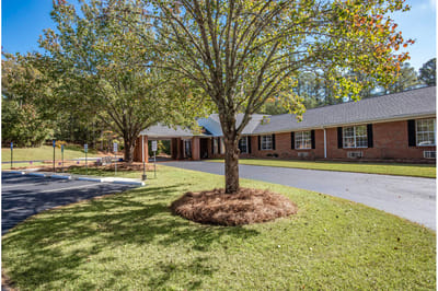 Exterior view of Haven Memory Care facility with trees
